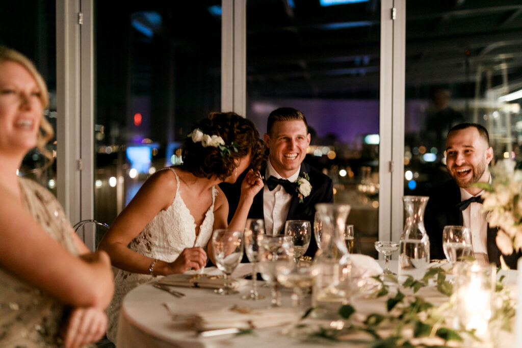 bride and groom laughing at candle dinner