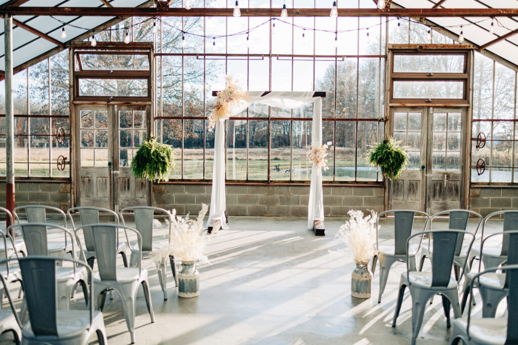Wedding arch in glass greenhouse