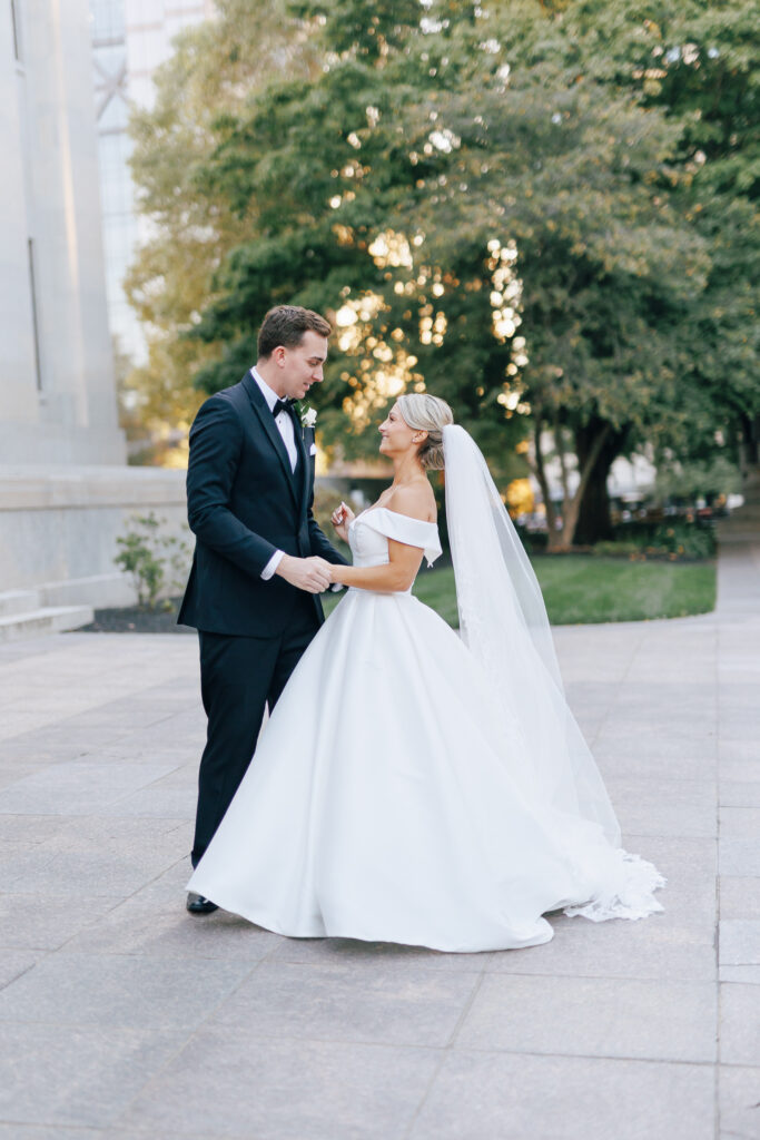 Bride and groom at sunset looking at each other on marble ground of the Ohio State House