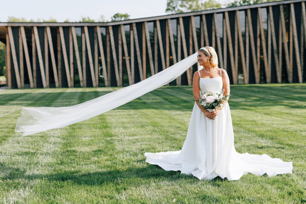 bride with long veil in front of mid century modern wedding venues i Columbus oh