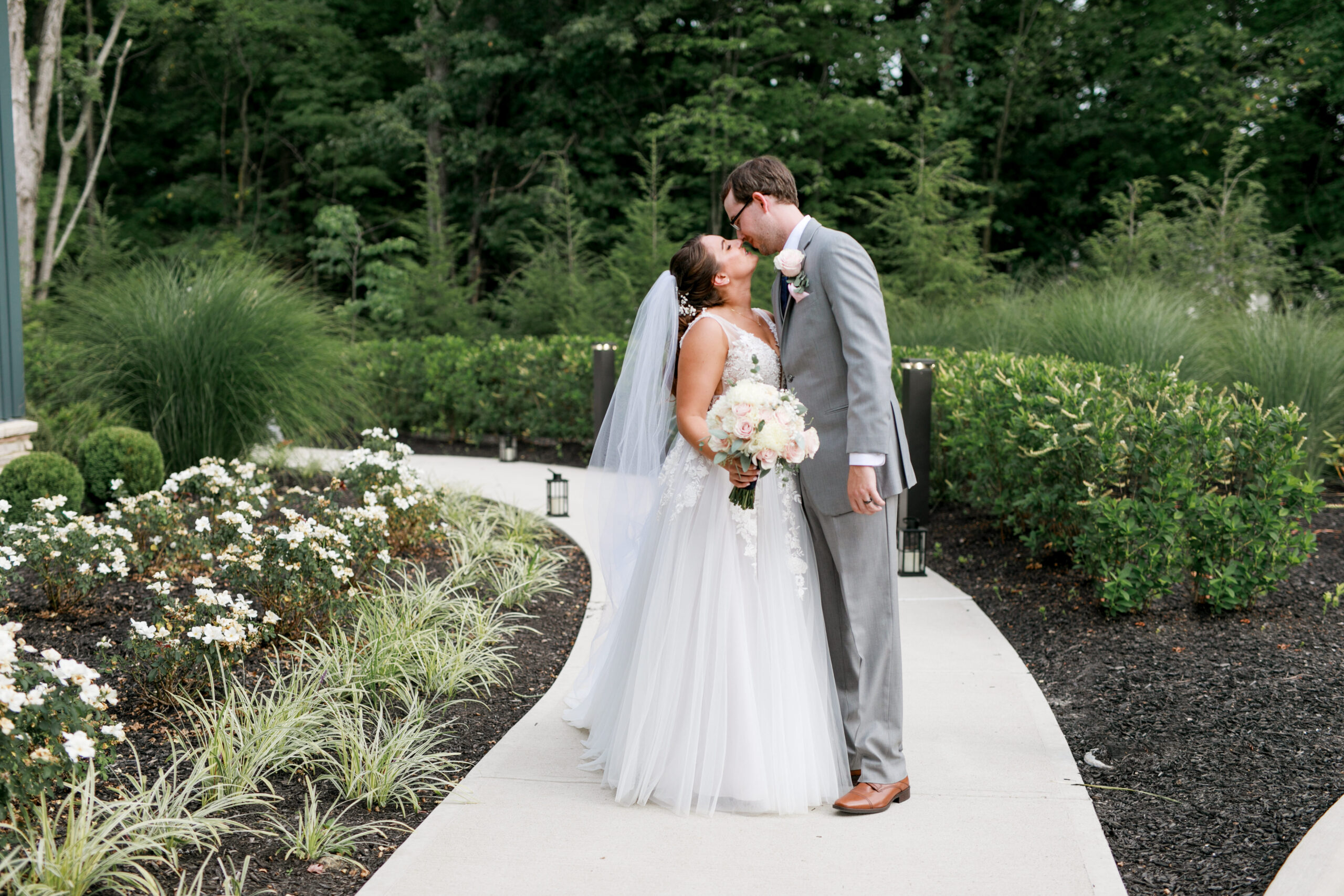 bride and groom kiss at the end of the aisle at The Estate at New Albany