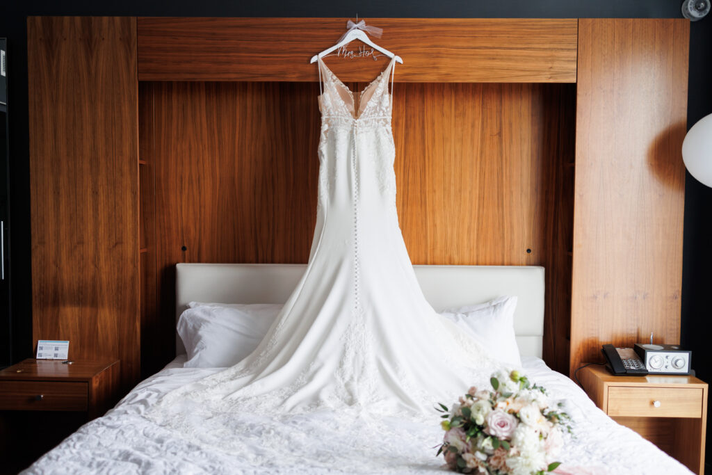 wedding gown on headboard of bed at Le Meridian Hotel