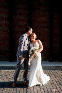 bride and groom in ally groom kisses brides forehead