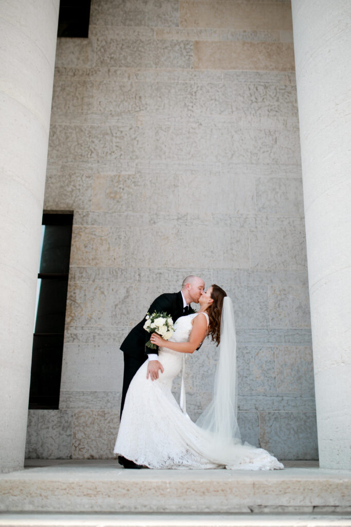 bride and groom kiss on the steps of the The Ohio Statehouse