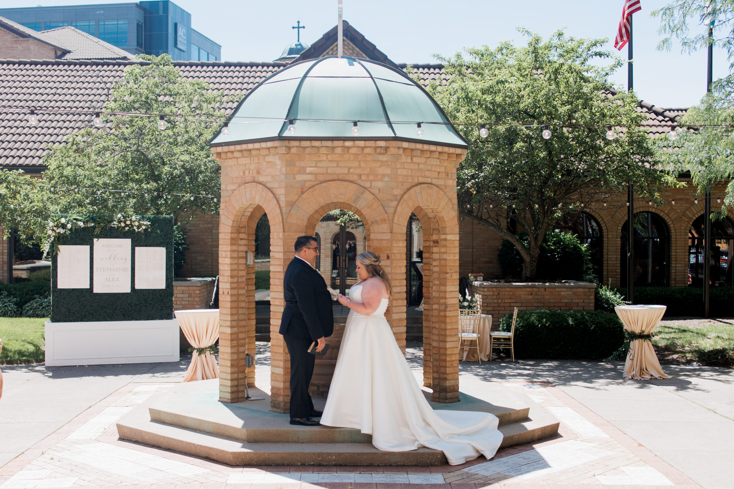 bride and groom reading vows in the courtyard of the Columbus Atheneum