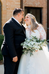 bride and groom looking at one another infront of the Columbus Atheneum