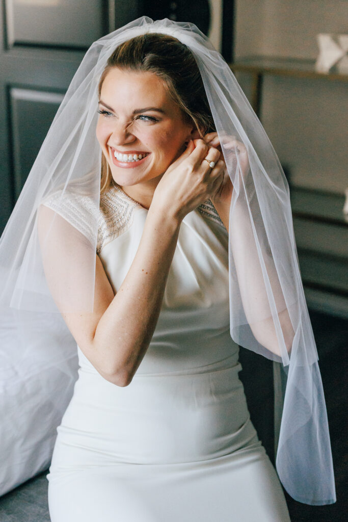 bride getting ready with earrings