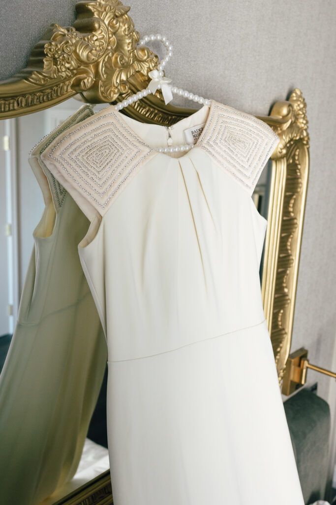 vintage wedding gown infront of gold mirror at the LeVeque hotel