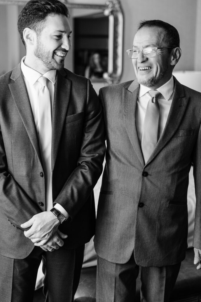 groom and father in suits at the leveque hotel