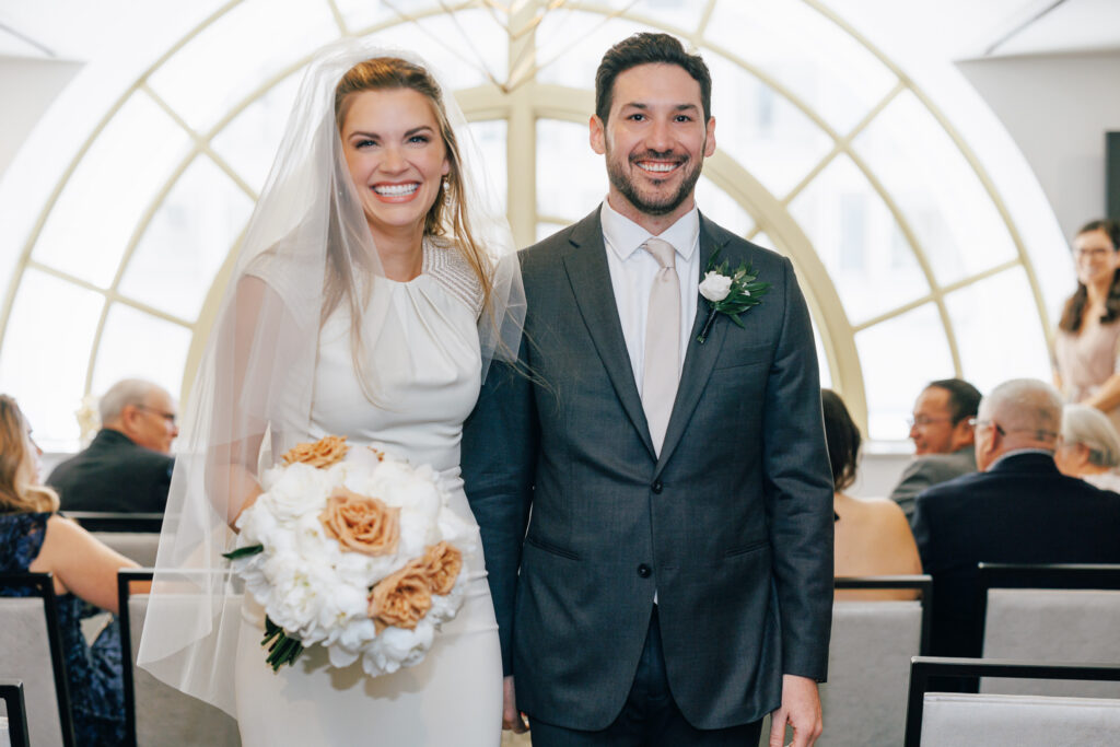 bride and groom after aisle at the leveque hotel