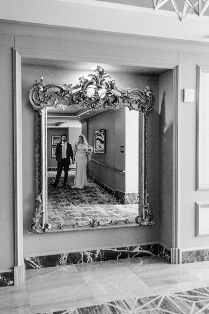 bride and groom in mirror reflection after wedding at leveque hotel