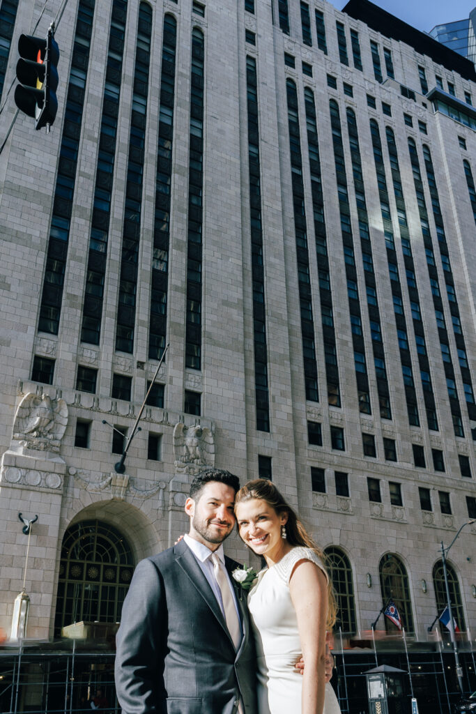 bride and groom standing infront of the leveque hotel